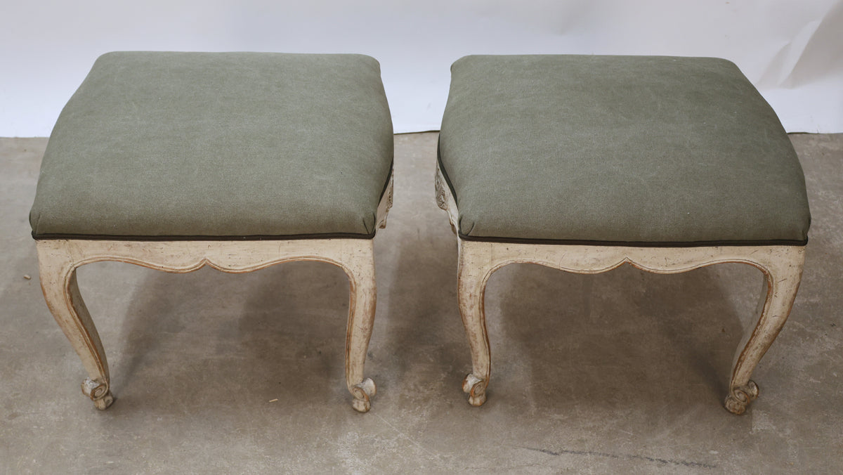 Antique tabourets with green fabric.