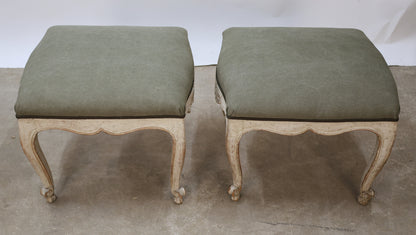 Antique tabourets with green fabric.