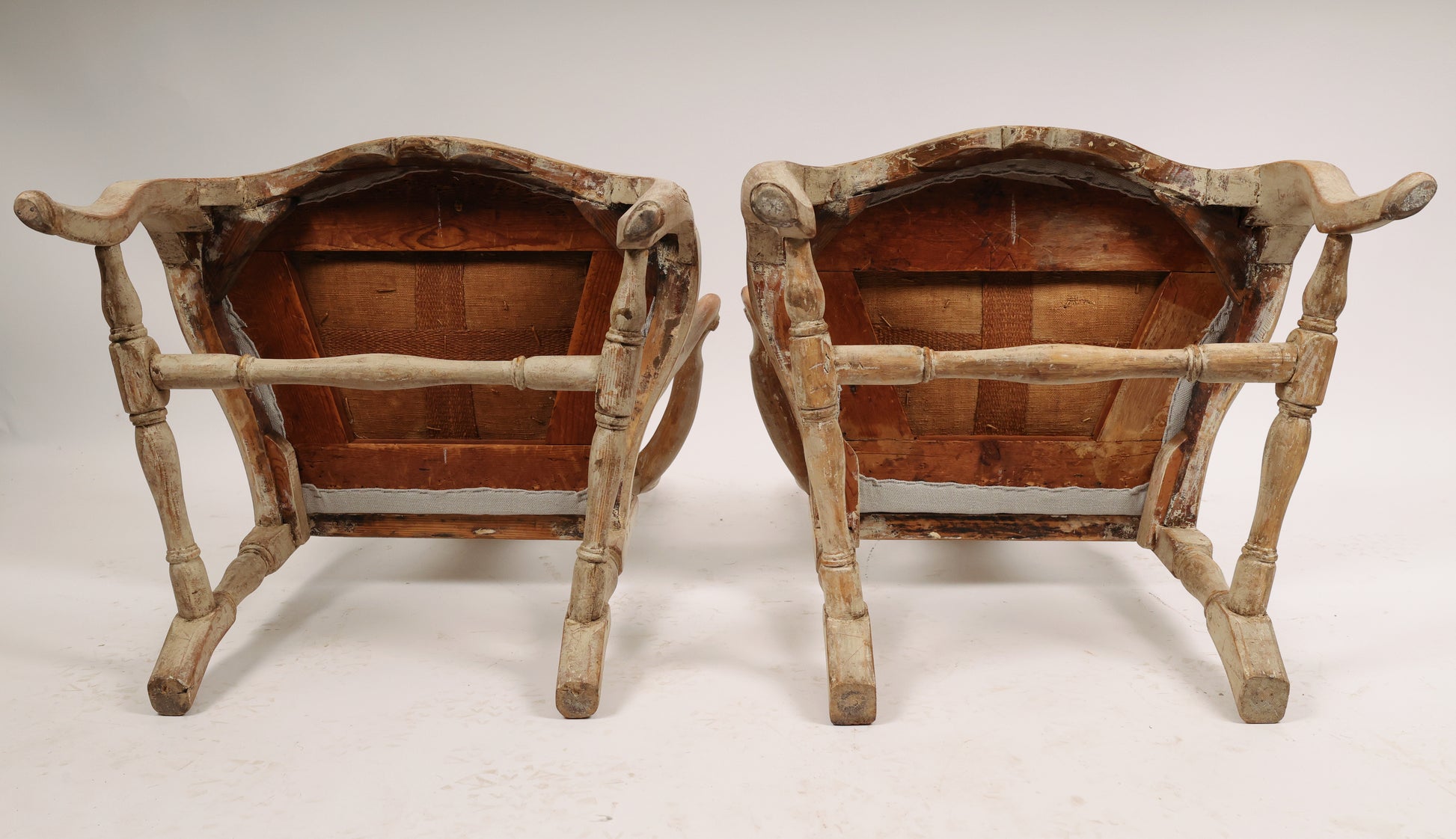 Underneath a pair of carved rococo armchairs from the 18th century.