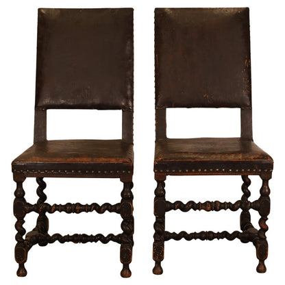 A pair of black Baroque chairs
