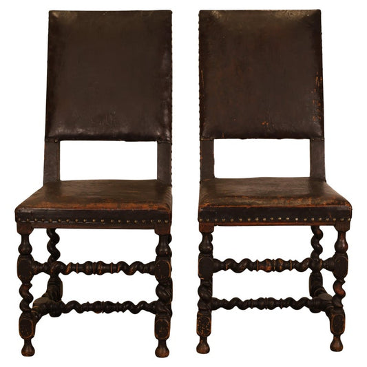 A pair of black Baroque chairs