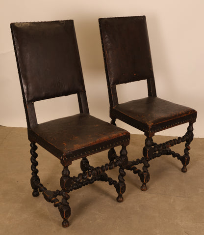A pair of Baroque chairs with leather for sale.