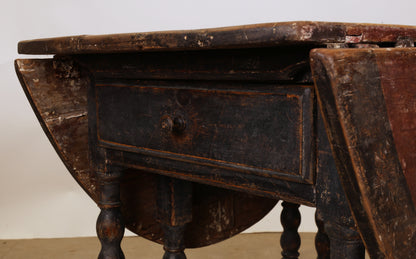 A drawer on a Baroque gateleg table.