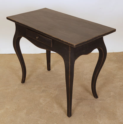 A black Rococo table.
