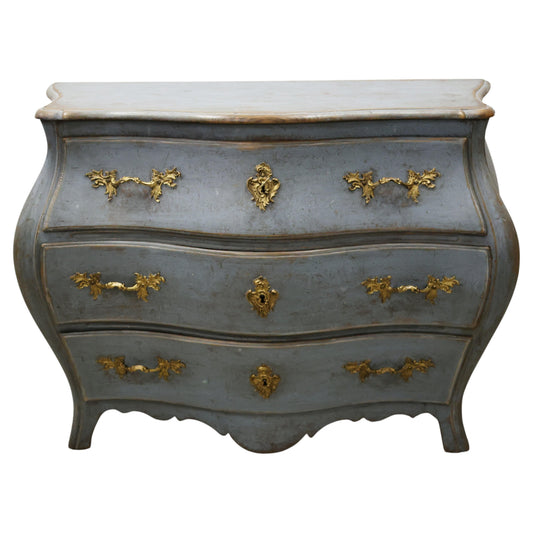 A blue chest of drawers made during the Rococo period.
