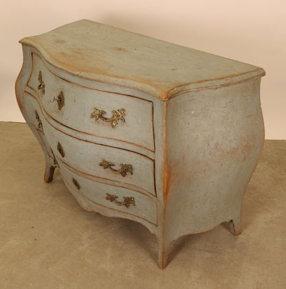 A blue rococo dresser.