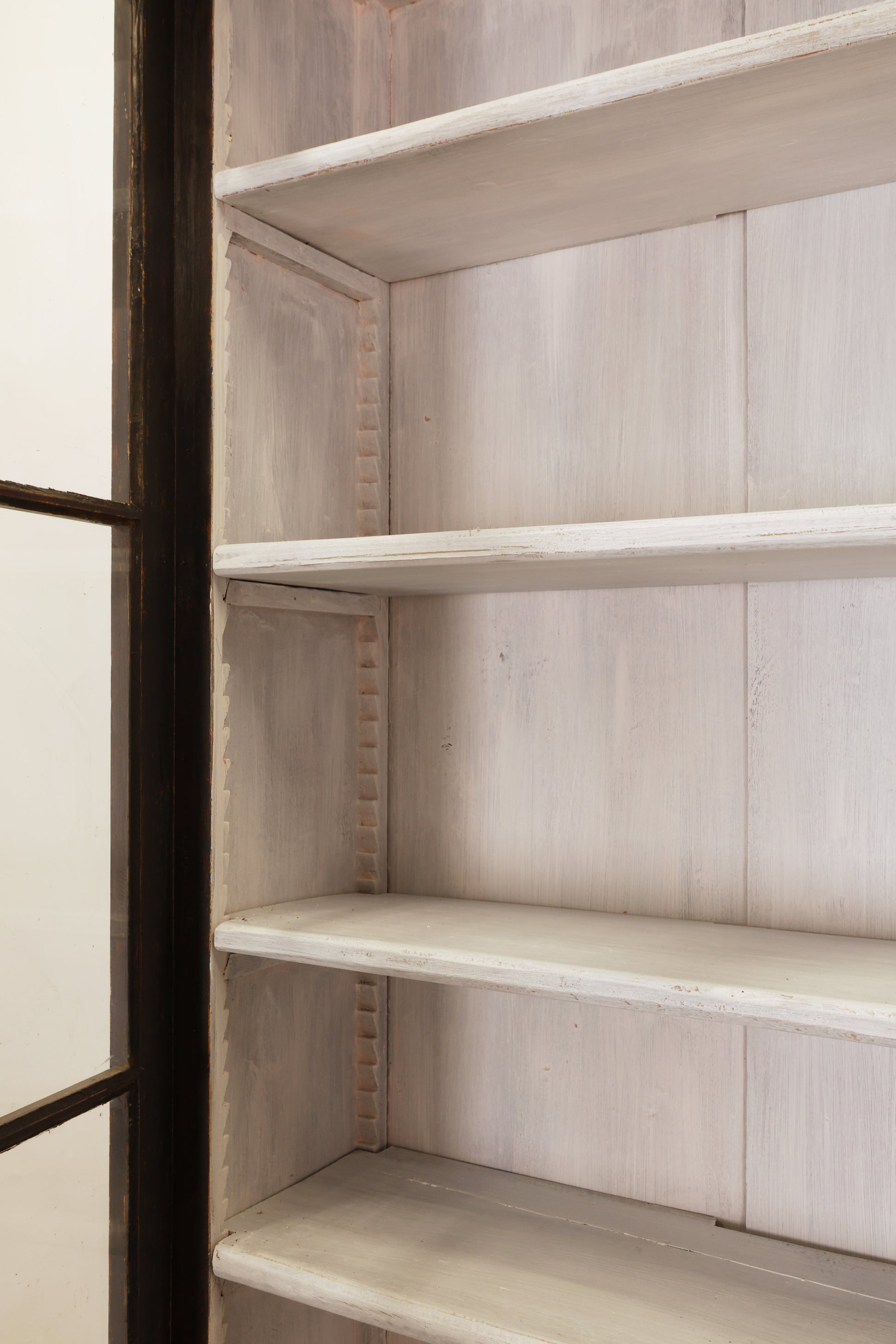 Shelves inside an antique Gustavian cabinet.