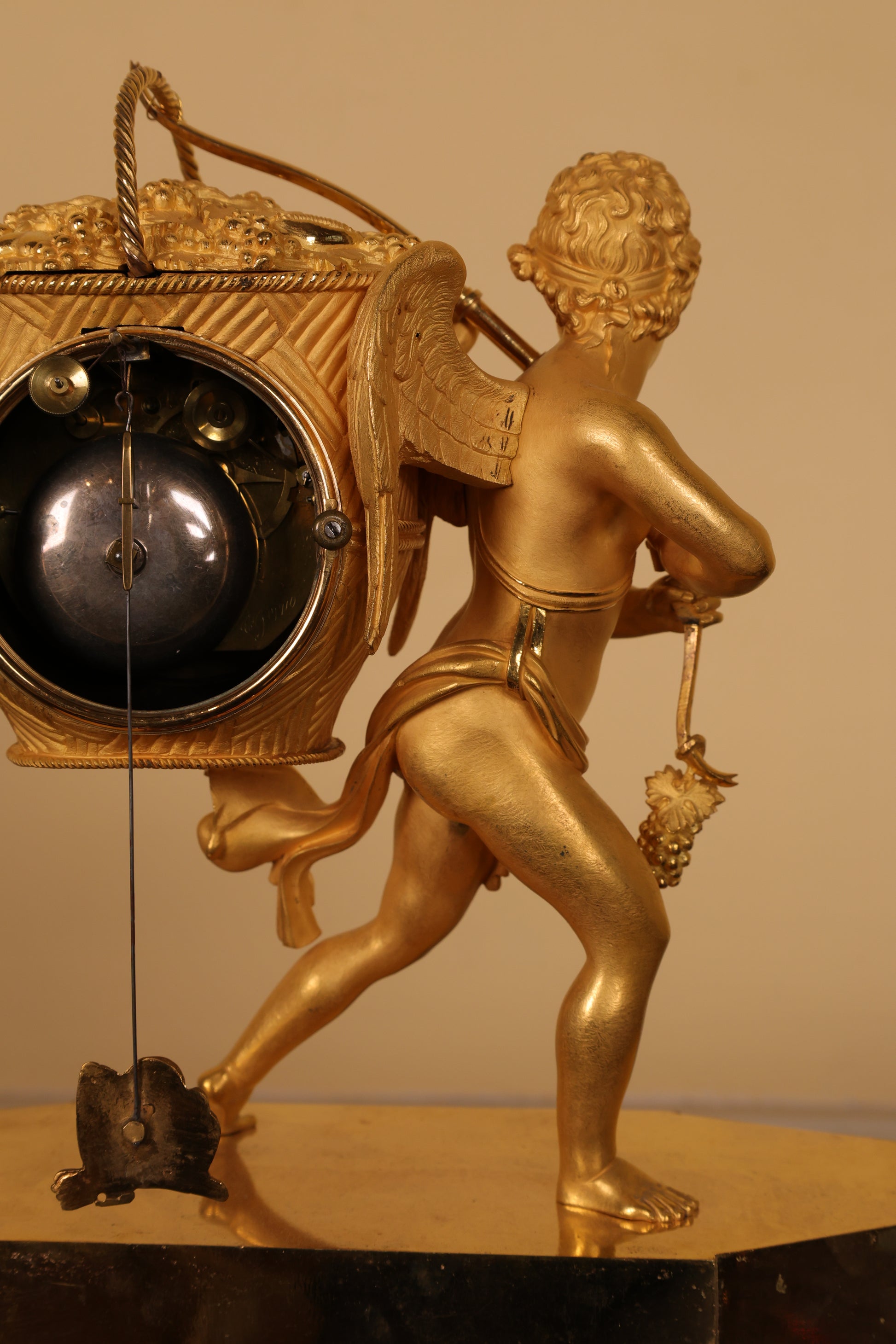 Back view of an fire-gilded bronze clock with putto.