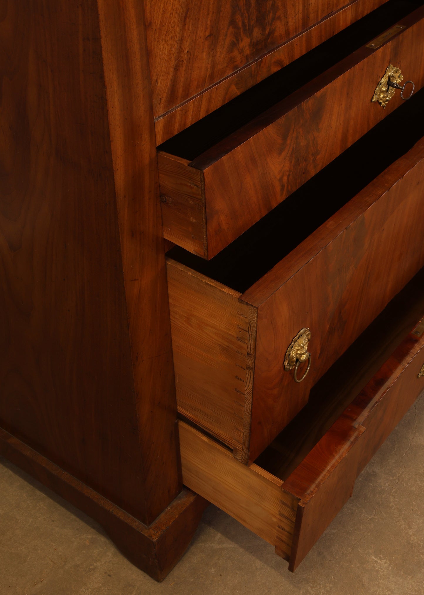 Close-up of the drawers on an Empire antique secretary.