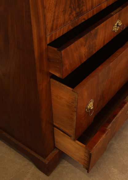 Close-up of the drawers on an Empire antique secretary.