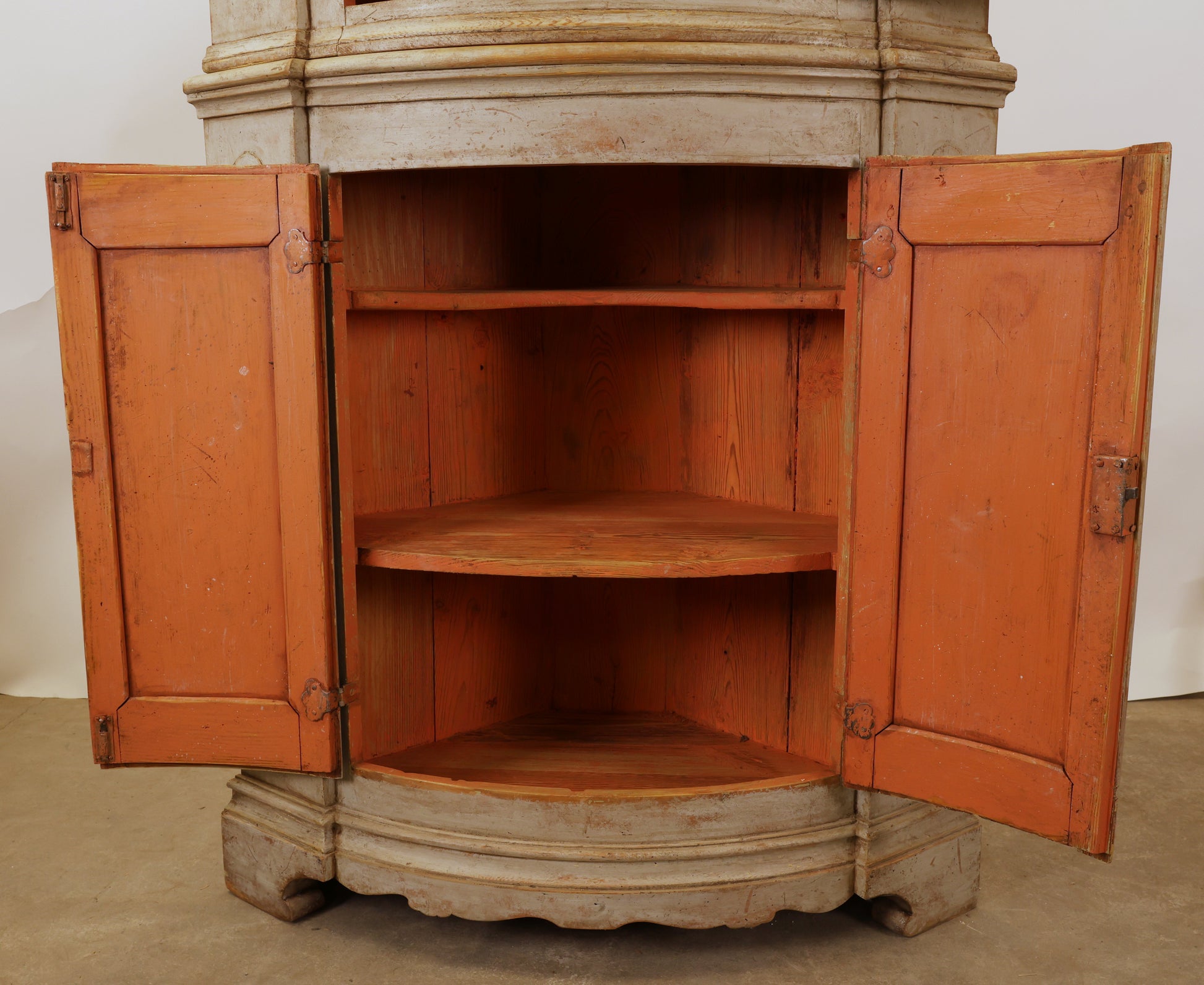 Opened doors on an antique corner Cabinet