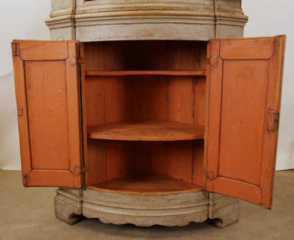 Opened doors on an antique corner Cabinet