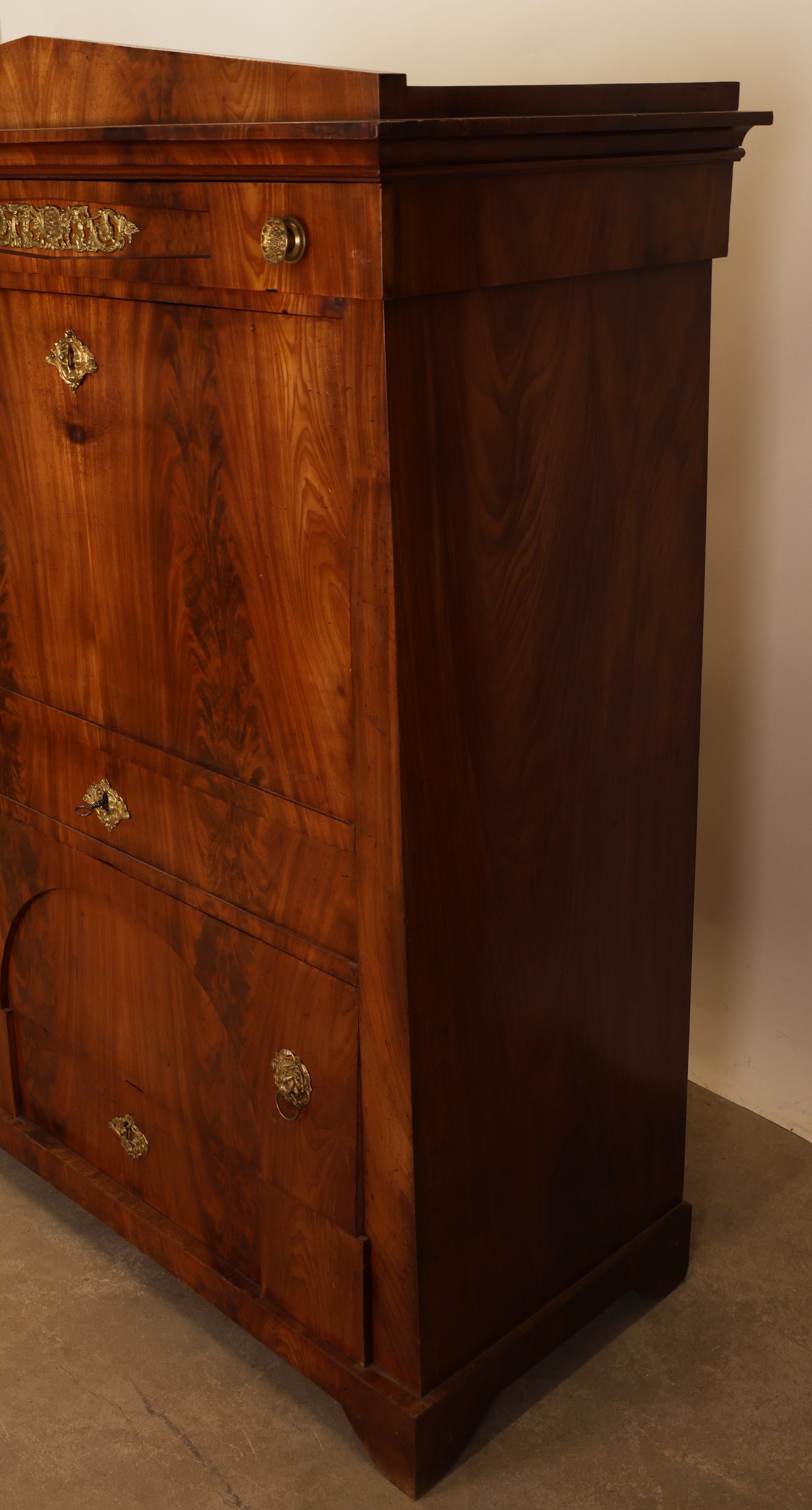 Empire antique furniture. A secretary desk viewed from the side.