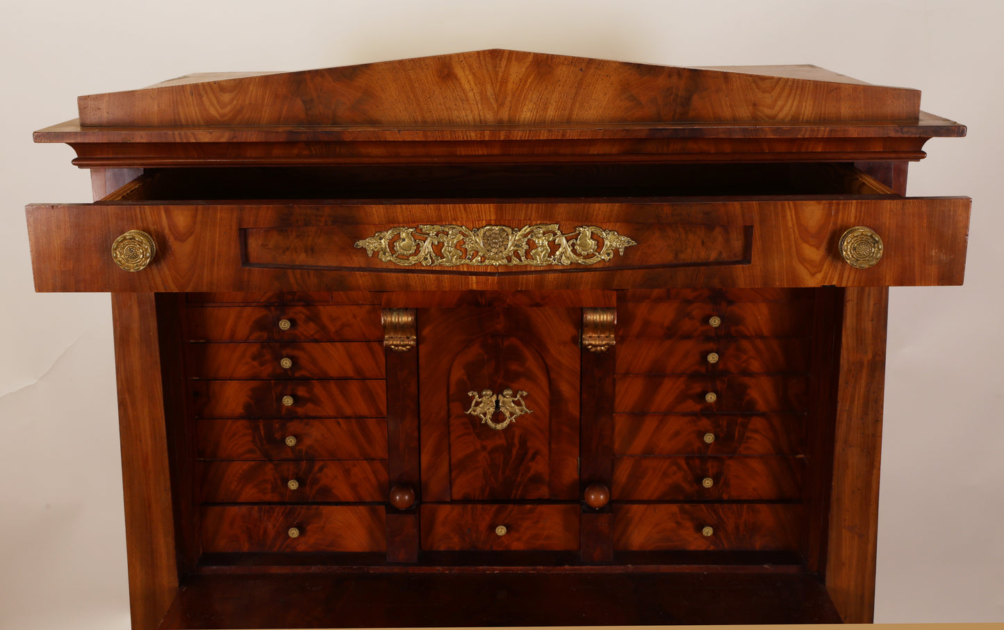 Gilded details on a beautiful antique Empire secretary desk.