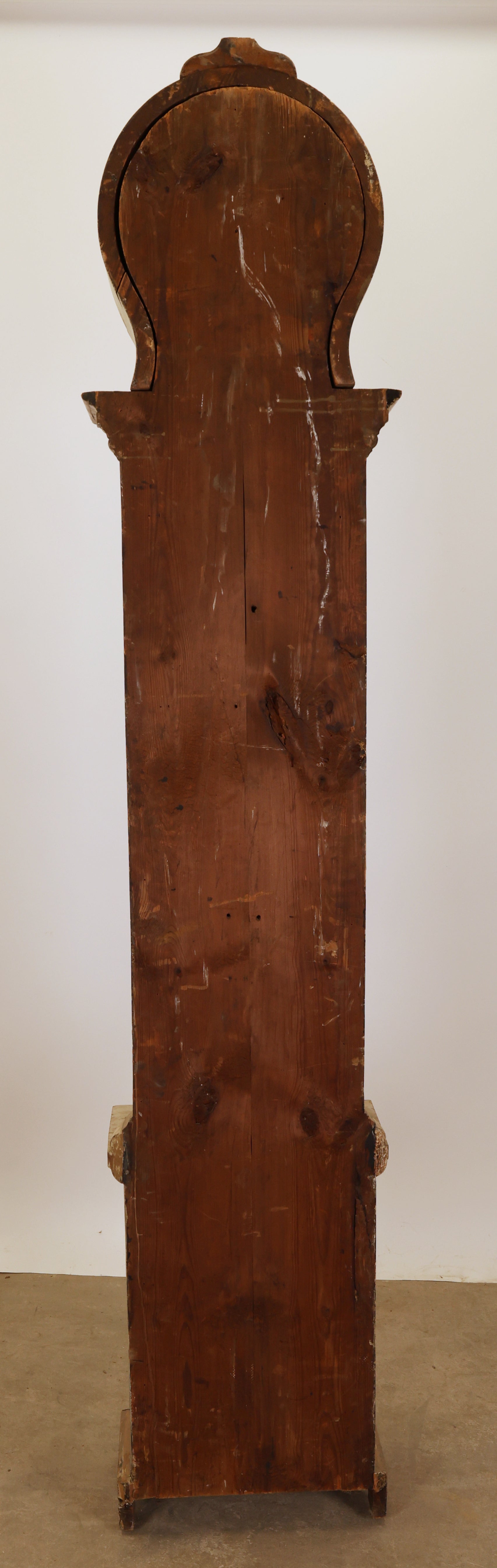 Antique longcase clock from behind.