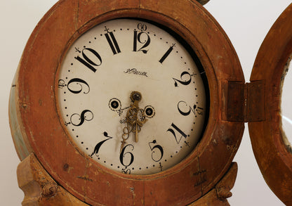 The movement on an antique grandfather clock.