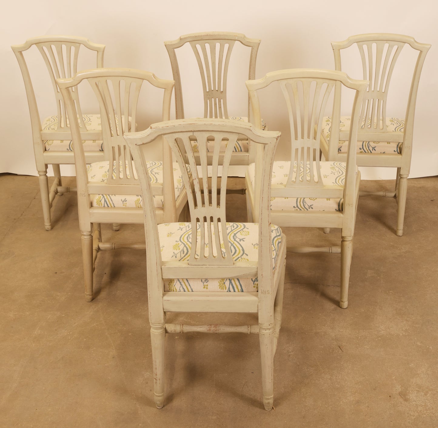 Back view of a six Gustavian antique chairs.