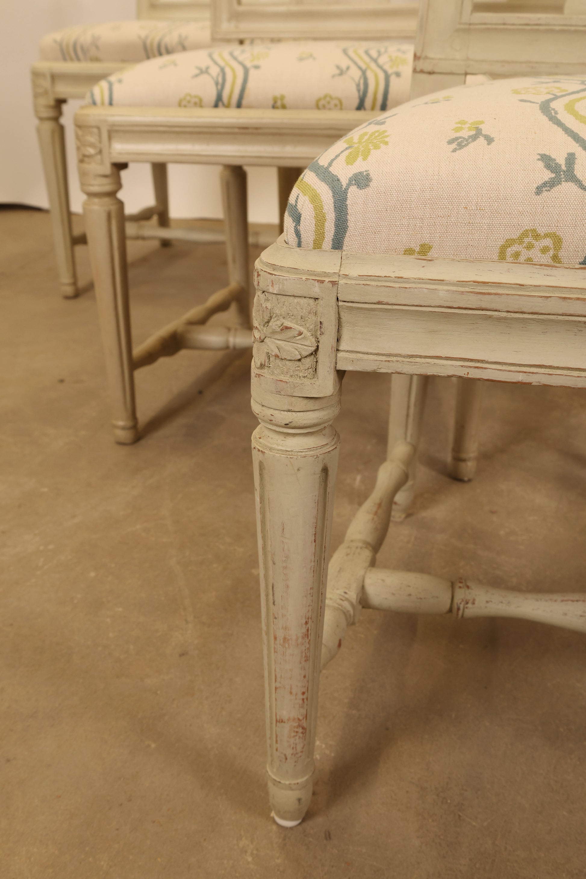 Close up of the legs of Gustavian chairs.