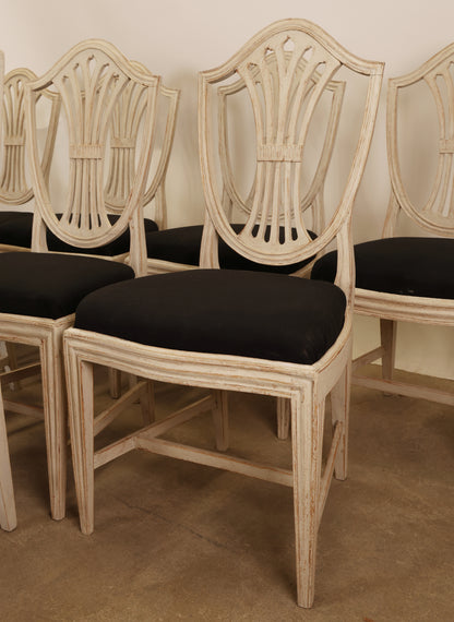 Gustavian chairs with black upholstery.
