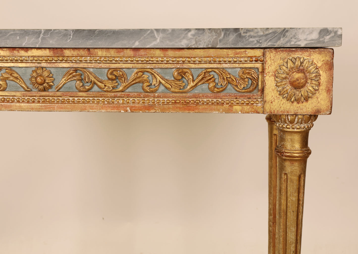 Carved and gilded sunflower decorations on a Swedish antique console table from the Gustavian period.