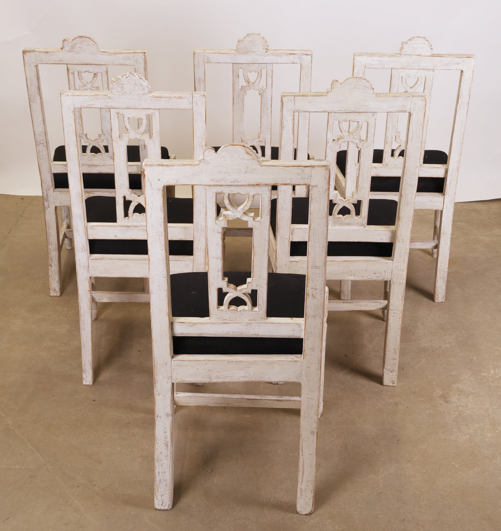 Six Gustavian chairs from behind.