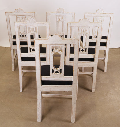 Six Gustavian chairs from behind.