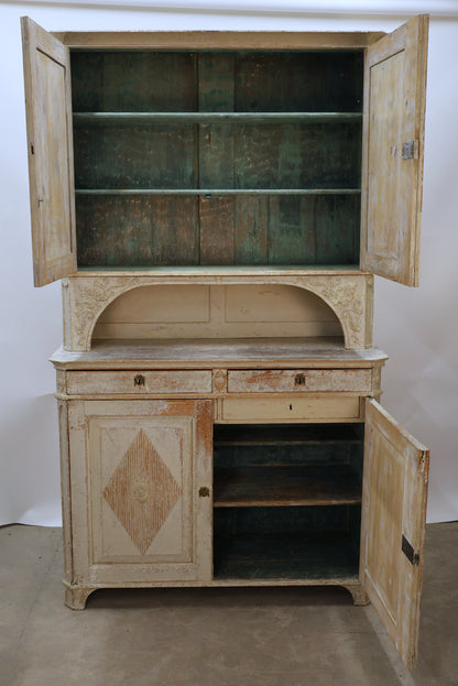 The shelves in a Gustavian sideboard cabinet.