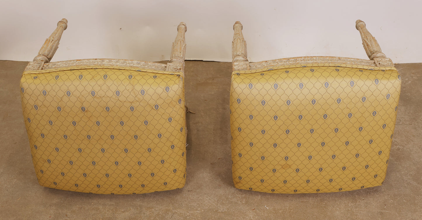 The yellow fabric of a pair of Gustavian stools.