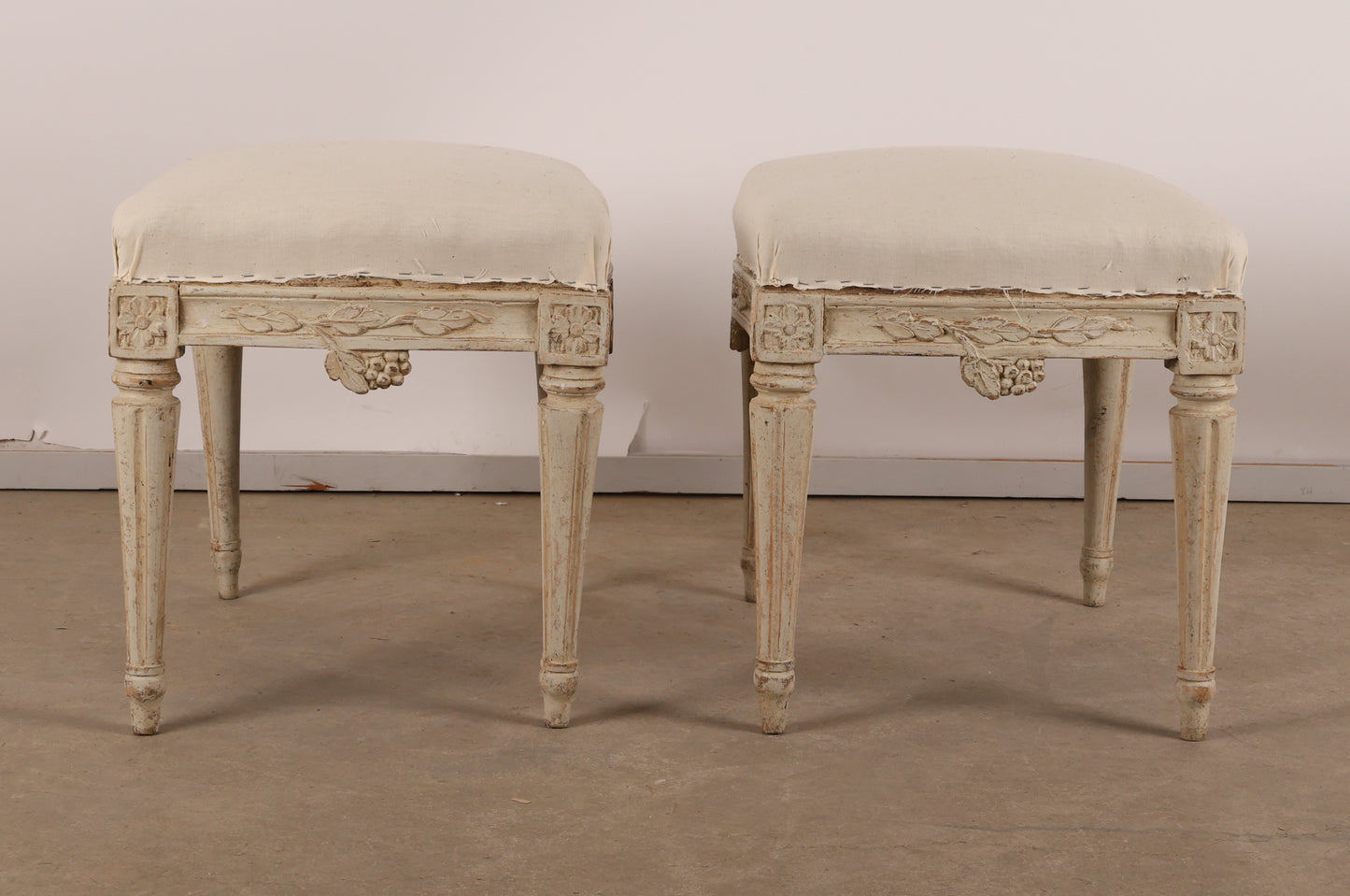 Pair of 18th Century Gustavian Stools signed Johan Erik Höglander with carved decorations of grapes, branches and corner rosettes. The legs are carved with flutings