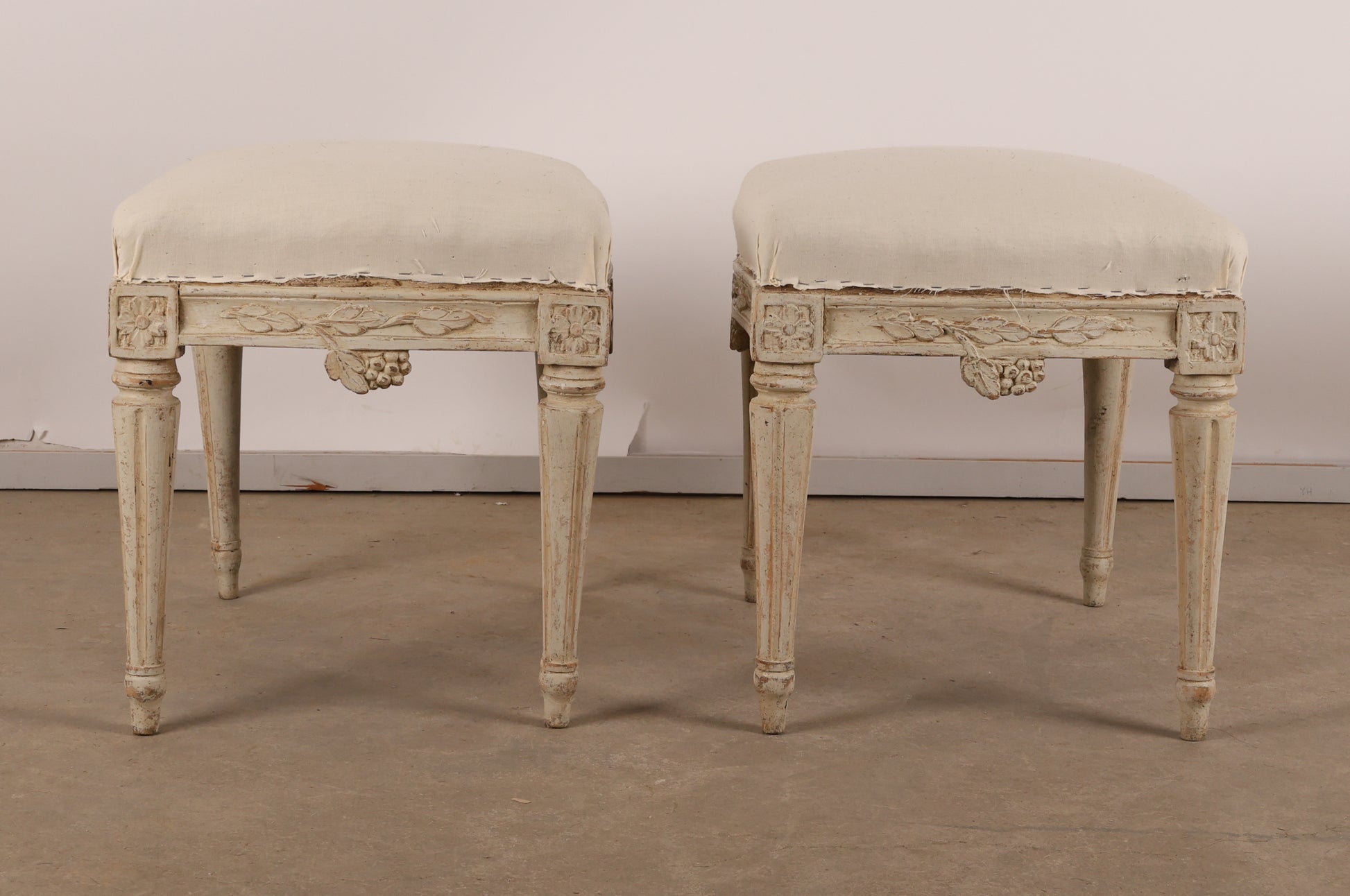 Pair of 18th Century Gustavian Stools signed Johan Erik Höglander with carved decorations of grapes, branches and corner rosettes. The legs are carved with flutings