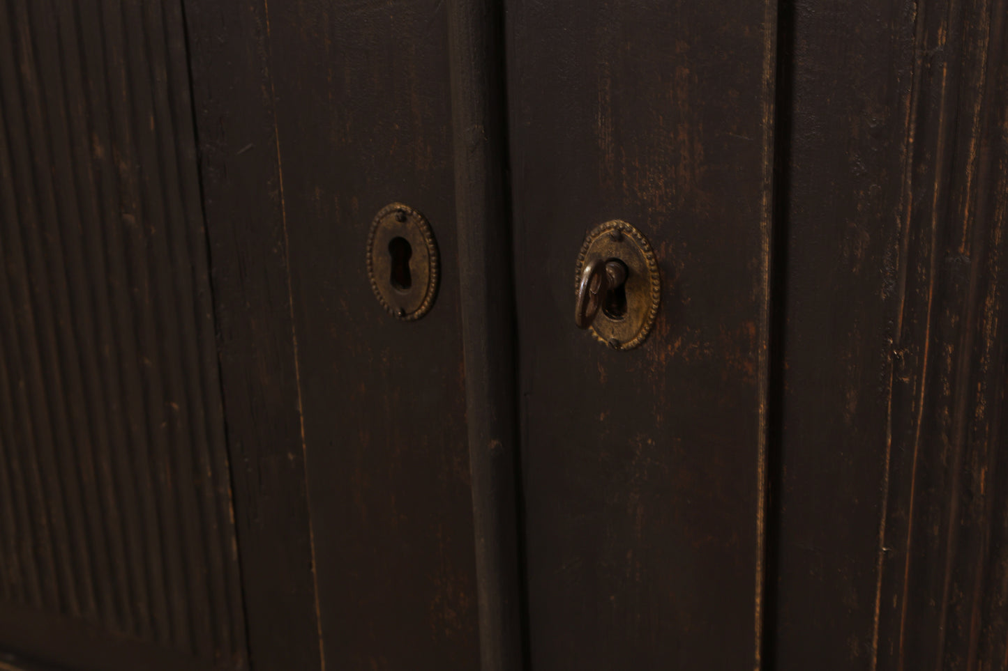 Key to a black antique cabinet.