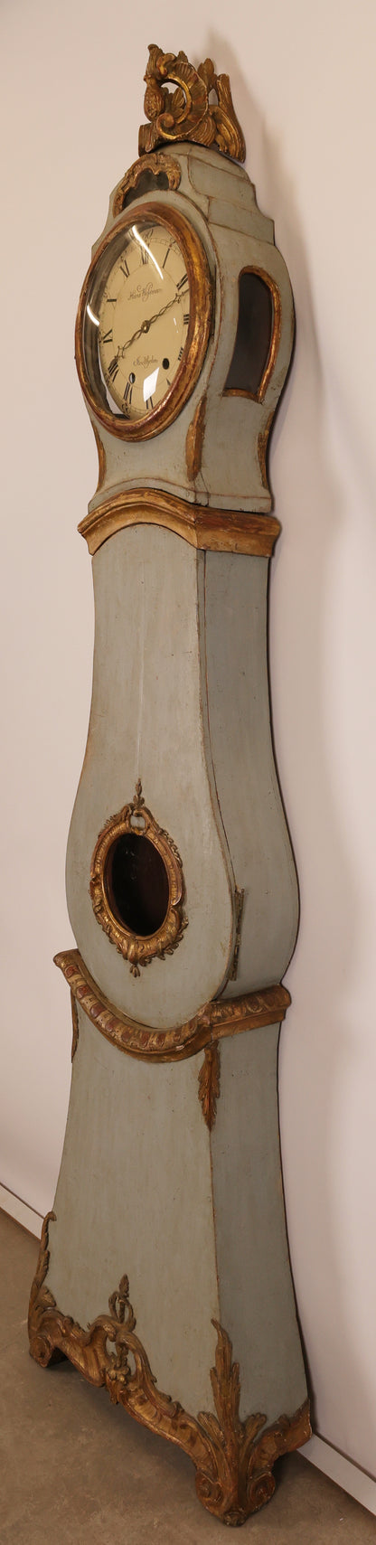 Side view of an 18th Century Rococo Grandfather Clock signed Hans Wessman with rich gilded carvings in typical Rococo forms.