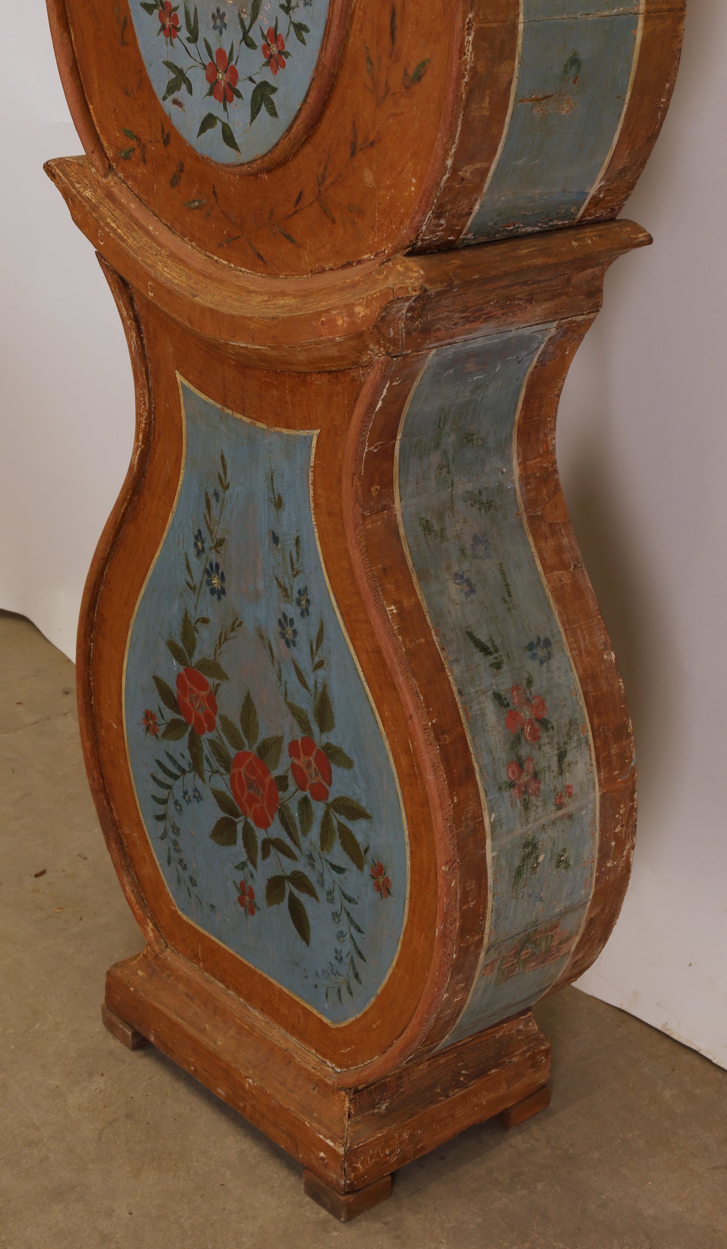 Painted flowers on an antique grandfather clock.