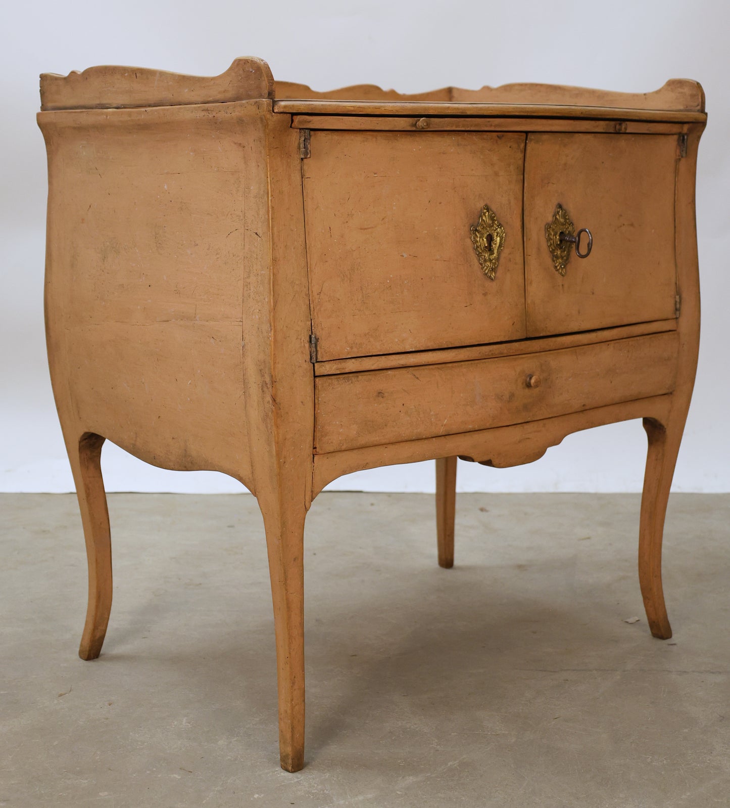 Pink Rococo nightstand with gilded fittings.