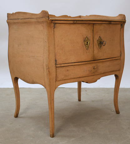 Pink Rococo nightstand with gilded fittings.