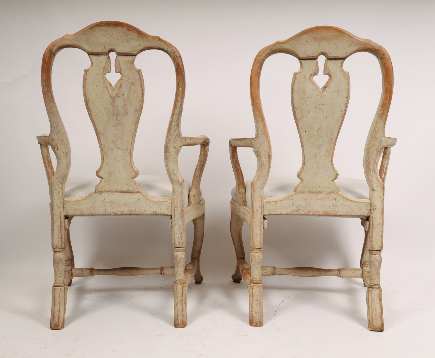 Backview of a pair of 18th century rococo armchairs.