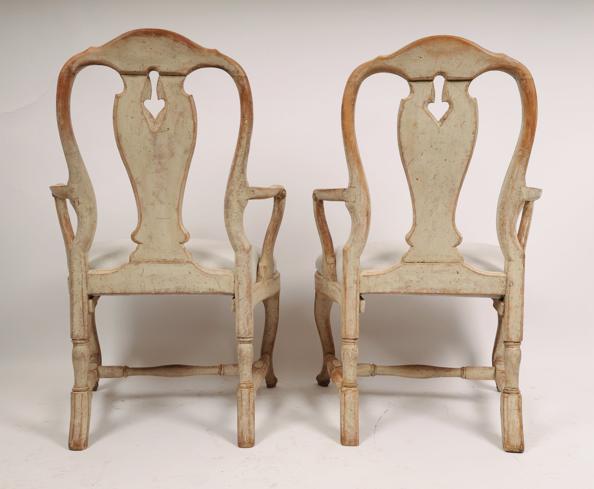 Backview of a pair of 18th century rococo armchairs.