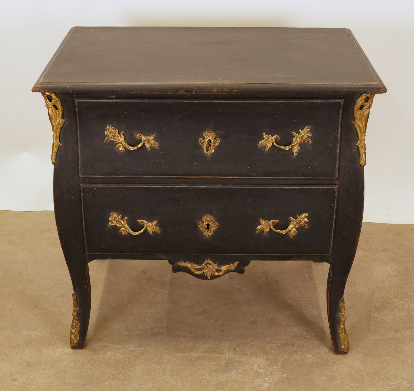 A black Rococo chest of drawers