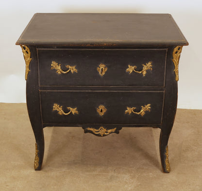 A black Rococo chest of drawers
