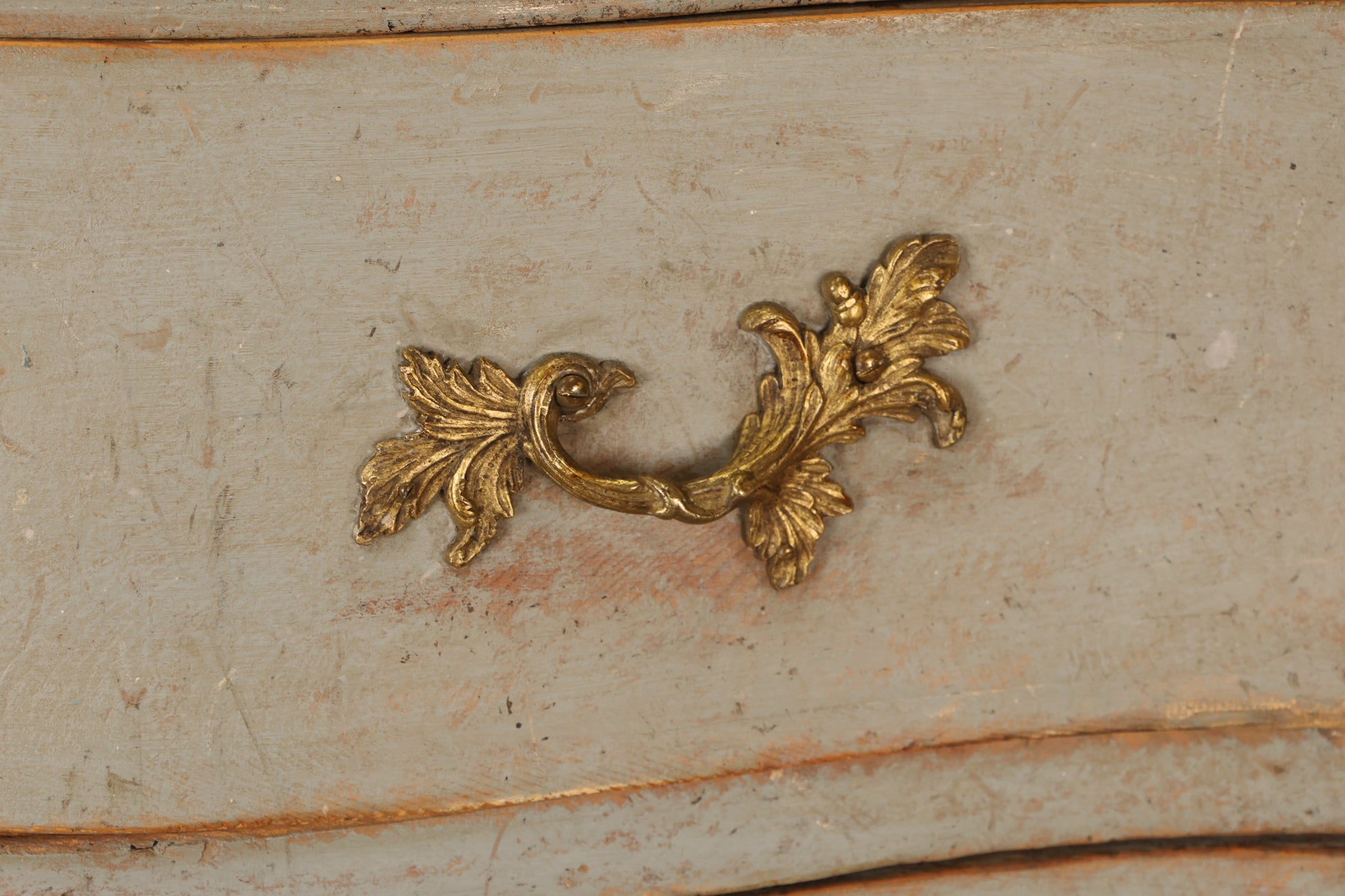 Gilded details on a Rococo chest of drawers.