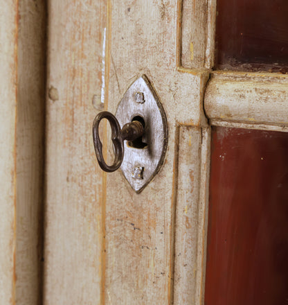 The key to a wooden Rococo corner cabinet.