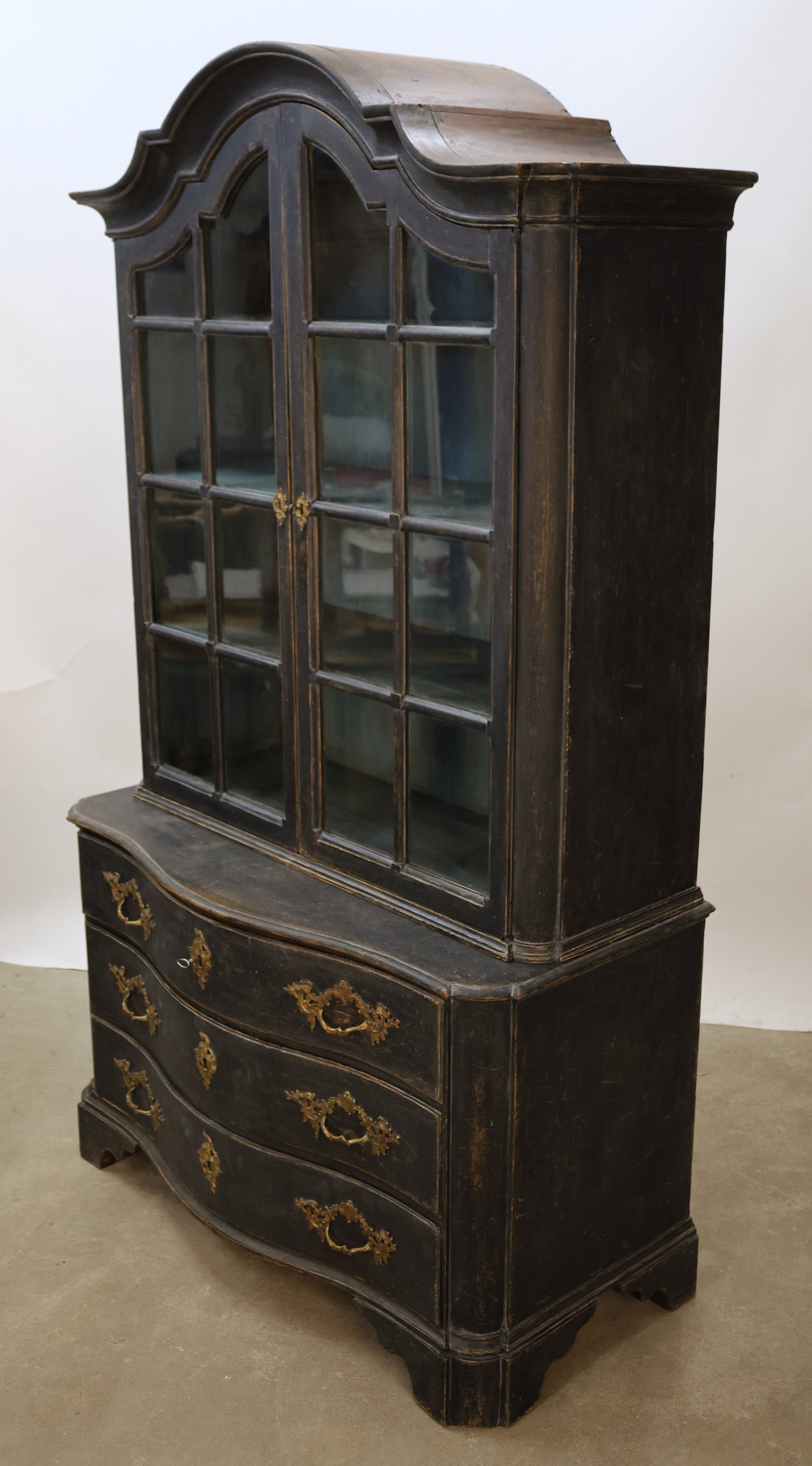 A black Rococo display cabinet featured in a selection of Rococo furniture.