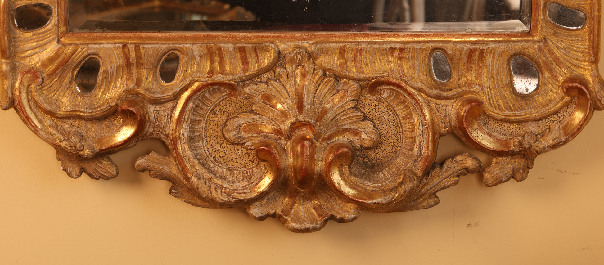 Gilded rocaille details on an 18th century Rococo Mirror.