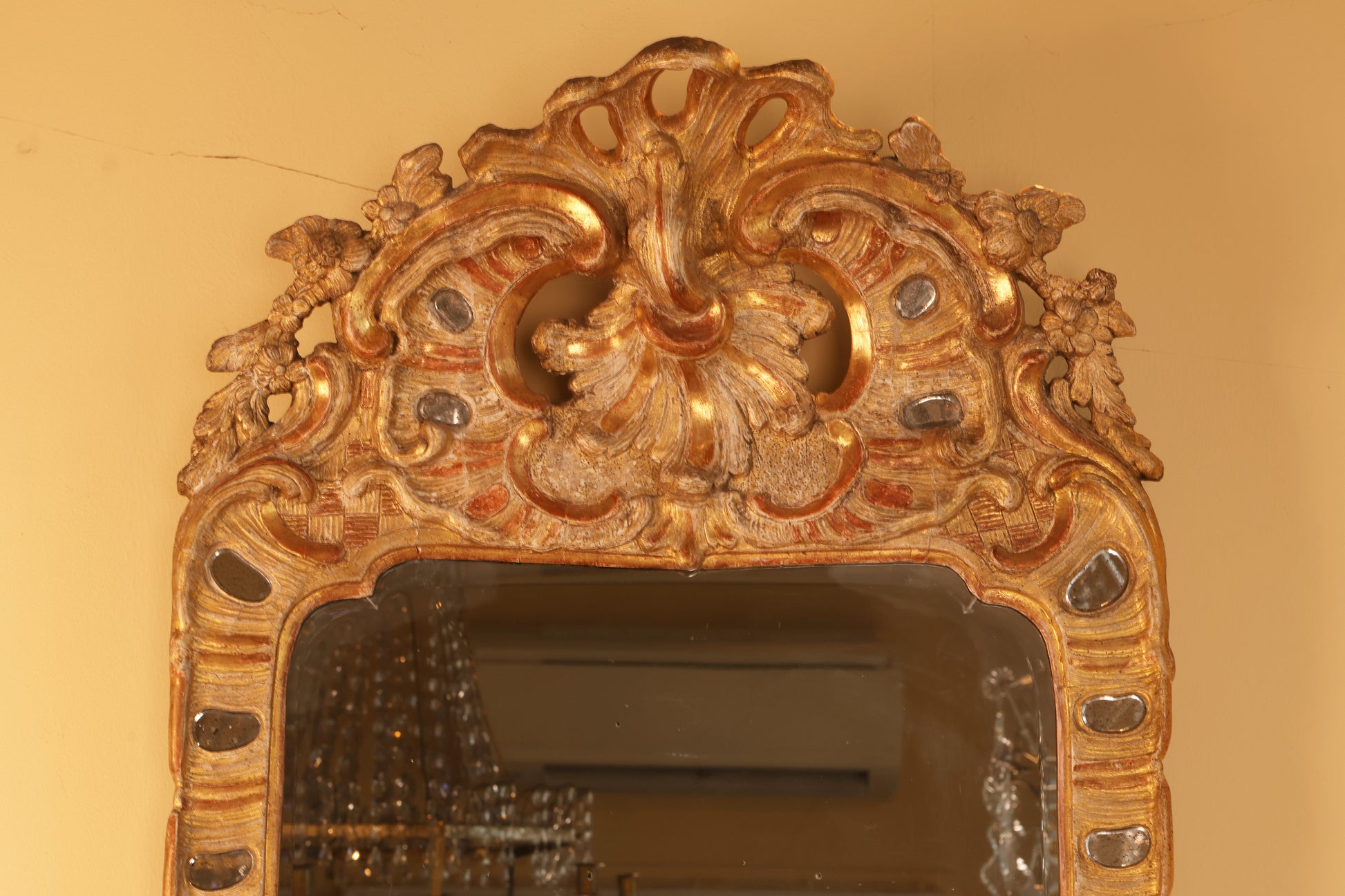 Gilded rocaille crown on an 18th century Rococo Mirror.