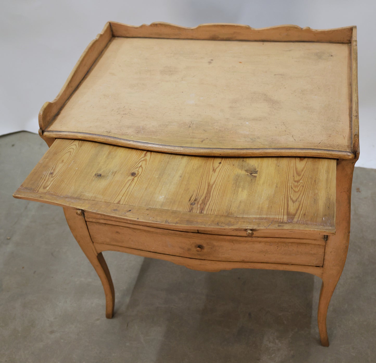 Antique nightstand from the Rococo epoch with a pulled out surface.