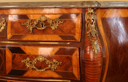 Close up of gilded rocailles on a Rococo commode
