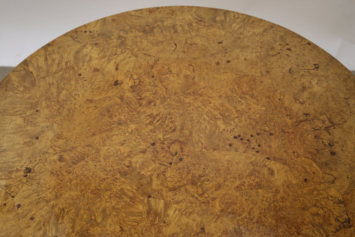 A root veneered table top on an antique folding table.