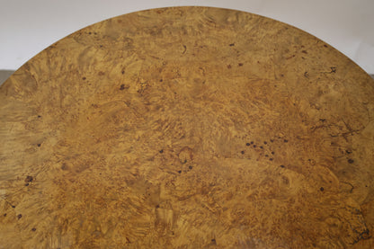 A root veneered table top on an antique folding table.