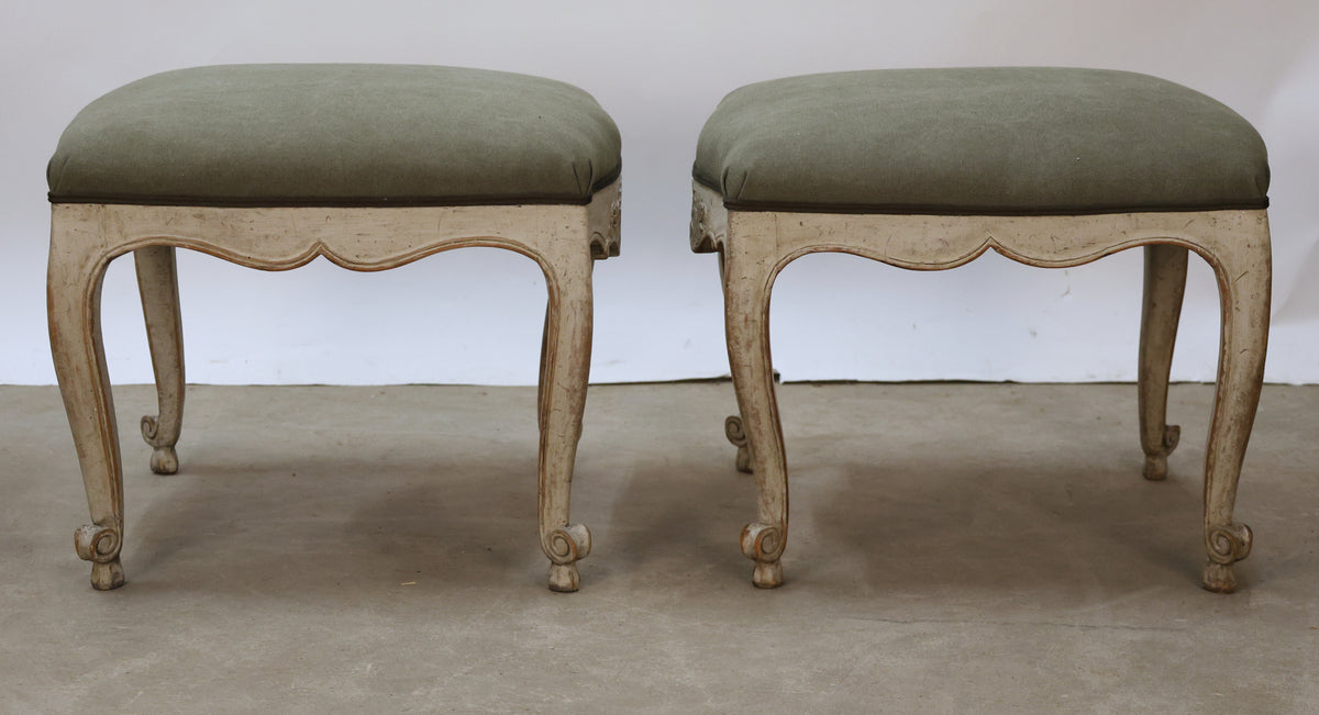 Antique furniture stools with green fabric.