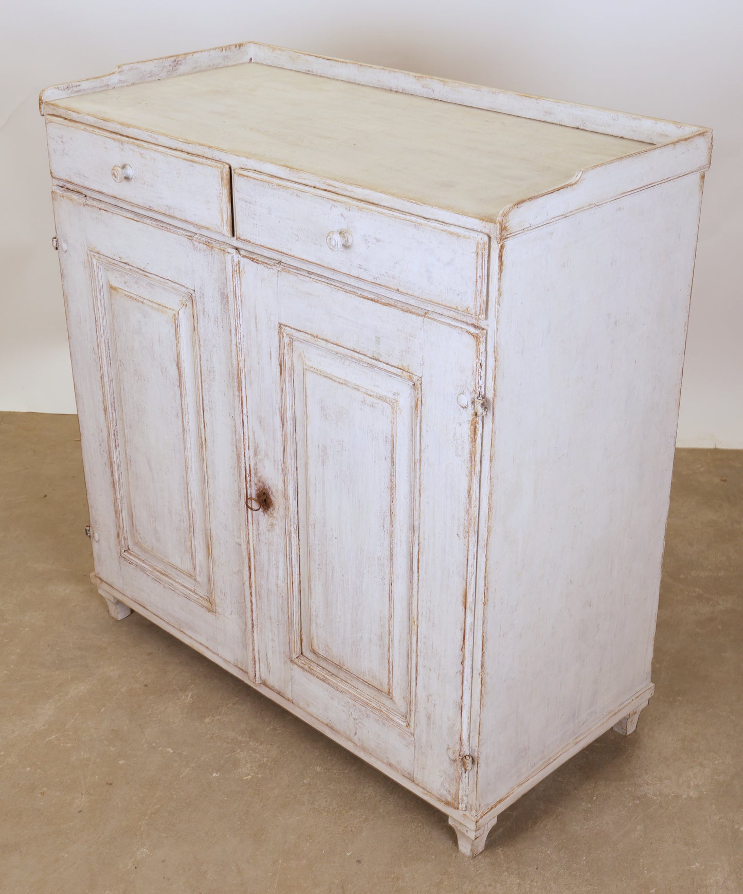 A white Swedish antique Gustavian sideboard.